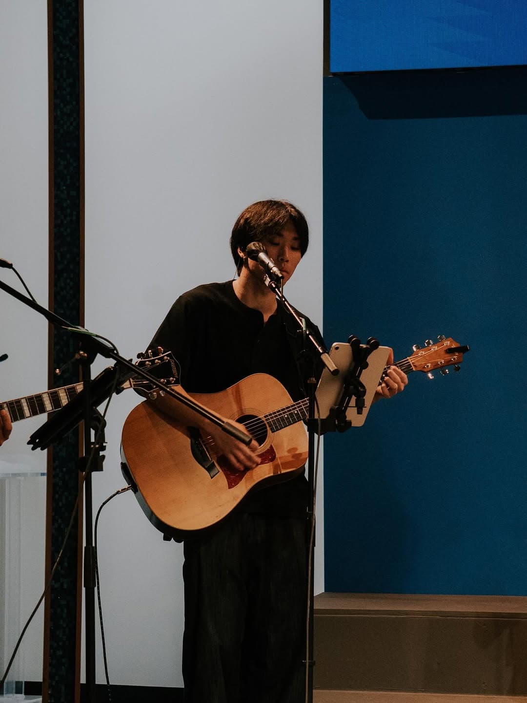 Worship leader playing acoustic guitar