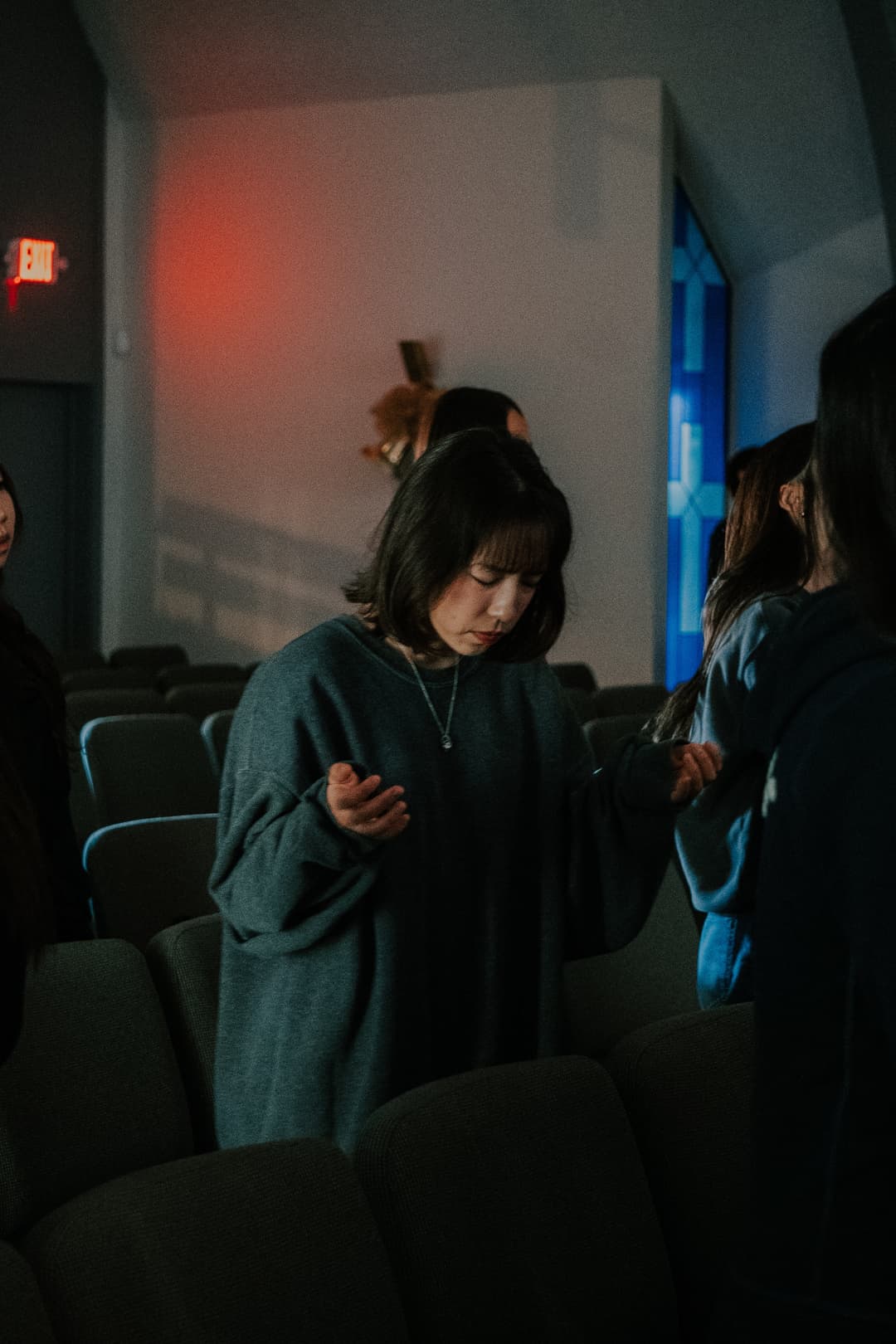 Woman in prayer at 1128 Ministry